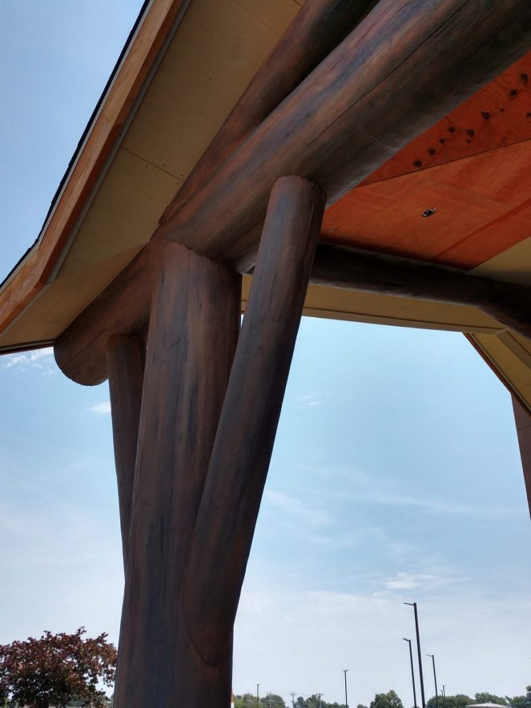 Giant steel beams designed to look like natural wooden logs hold up the porte cochere entry at the Cherokee Casino Resort.