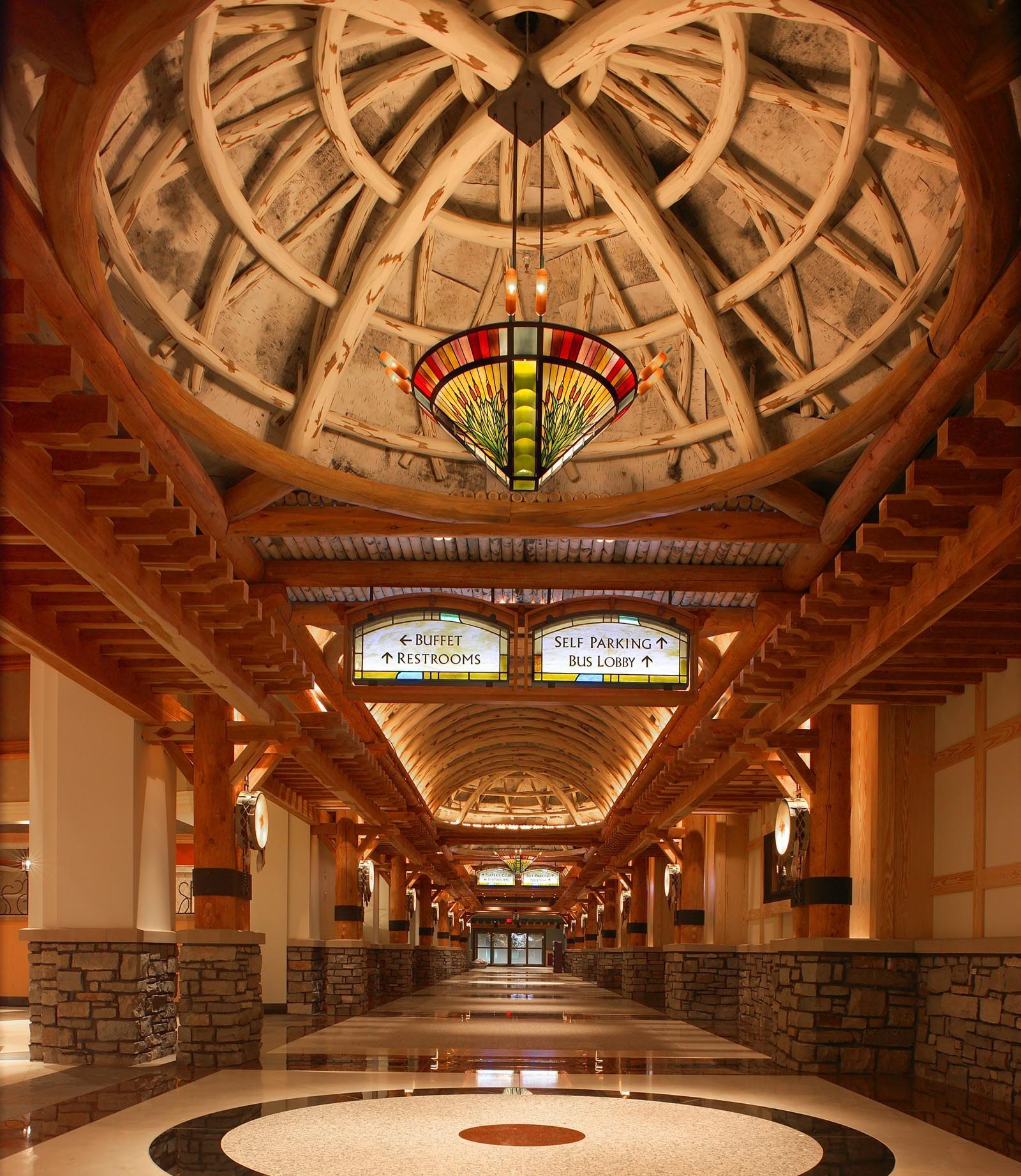 4windsprominade (2) Interior ceiling details at the 4 Winds casino show a long hallway ceiling with signage and theme design.