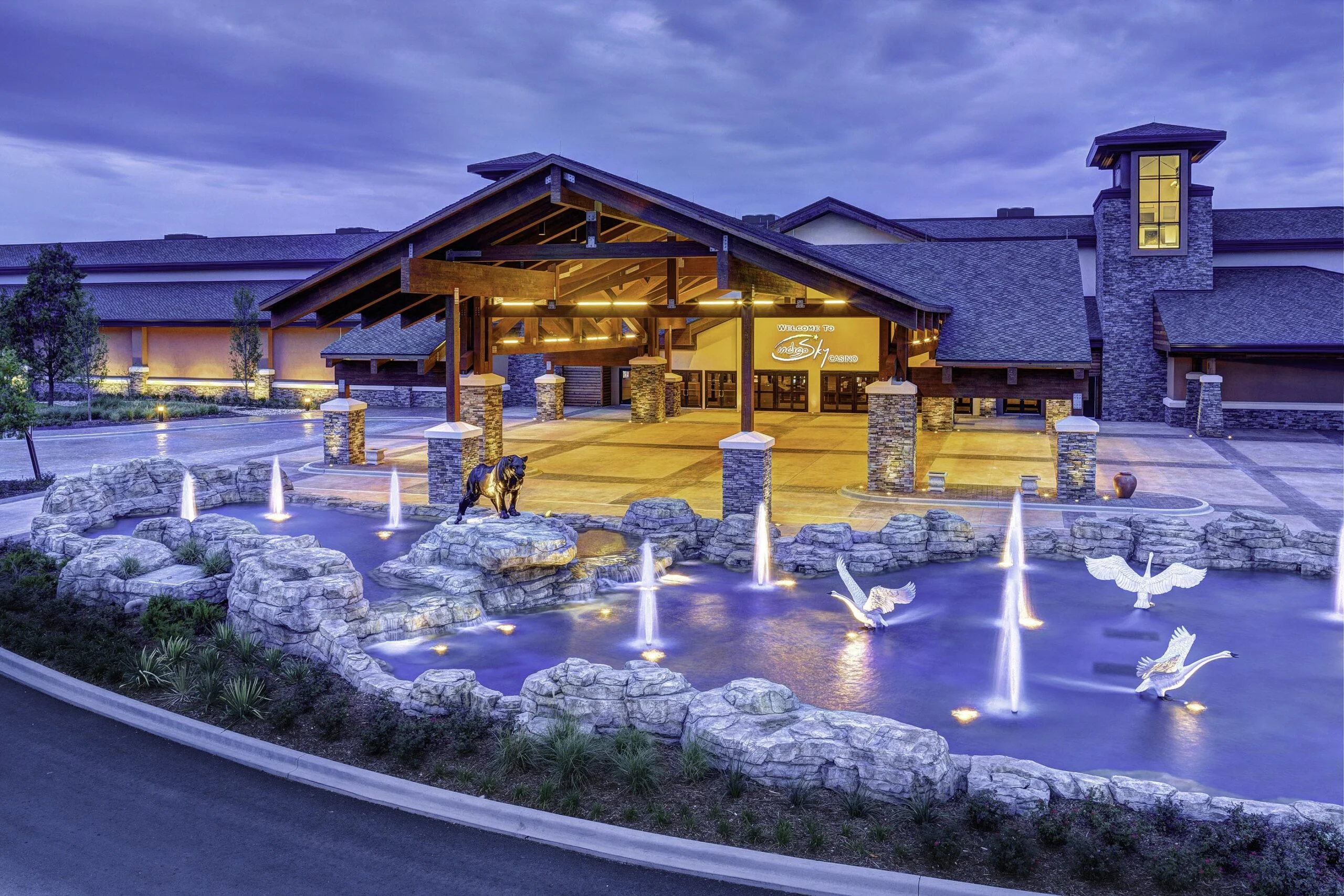 A large pool welcomes visitors to this wilderness themed casino. The water feature has spouts of water and rock pillars, accented with underwater lights.